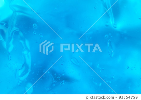 Texture of transparent antiseptic gel with air bubbles on blue background. Summer ocean imitation. Concept of skin moisturizing, prevention of virus. Liquid beauty product closeup. Backdrop, flat lay Texture of transparent antiseptic gel with air bubbles on blue background. Summer ocean imitation. Concept of skin moisturizing, prevention of virus. Liquid beauty product closeup. Backdrop, flat lay 93554759