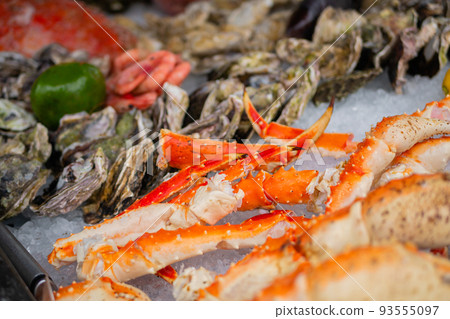 Crab claws on counter at summer local fish market - close up Crab claws on counter at summer local fish market - close up 93555097