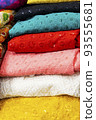 multicolored Indian women's shawls made of silk and cotton in the shop window. 93555681