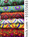 multicolored Indian women's shawls made of silk and cotton in the shop window. 93555683