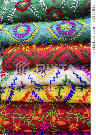 multicolored Indian women's shawls made of silk and cotton in the shop window. multicolored Indian women's shawls made of silk and cotton in the shop window. 93555683