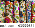 multicolored Indian women's shawls made of silk and cotton in the shop window. 93555684