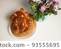 freshly baked assorted rolls with a stuffing in a white plate on the table. 93555695