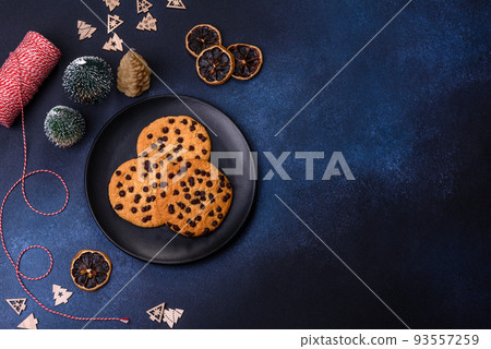 Christmas decorations and gingerbreads on a dark concrete table Christmas decorations and gingerbreads on a dark concrete table 93557259