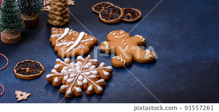 Christmas decorations and gingerbreads on a dark concrete table 93557261