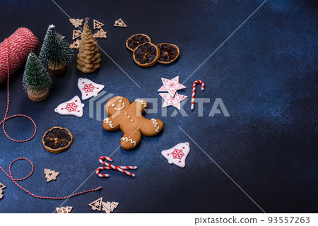 Christmas decorations and gingerbreads on a dark concrete table Christmas decorations and gingerbreads on a dark concrete table 93557263