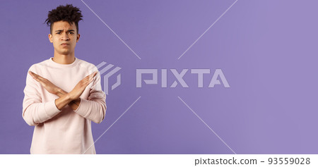 Portrait of young fed up man express his strong will to end this relationship, cross hands over chest in stop, enough gesture pouting and frowning, looking serious, disagree and prohibit action 93559028