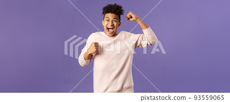 Portrait of excited happy man seeing his team scored goal on sports tv channel, chanting raise one hand in triumph, screaming in joy and happiness, celebrating victory, placed right bet Portrait of excited happy man seeing his team scored goal on sports tv channel, chanting raise one hand in triumph, screaming in joy and happiness, celebrating victory, placed right bet 93559065