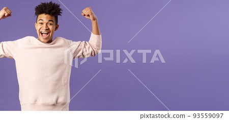 Portrait of young happy man got scholarship, applied to cool university, raise hands up flex biceps like champion, triumphing from great news, achieve goal and rejoicing, purple background Portrait of young happy man got scholarship, applied to cool university, raise hands up flex biceps like champion, triumphing from great news, achieve goal and rejoicing, purple background 93559097