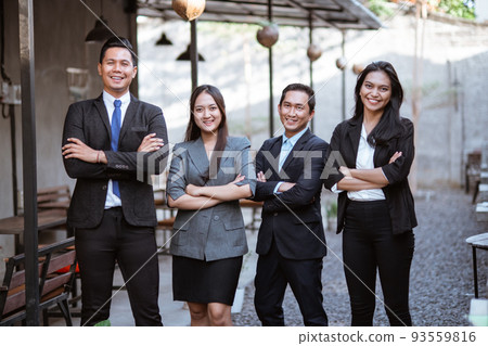 business asian partner smiling to camera with crossed arm 93559816