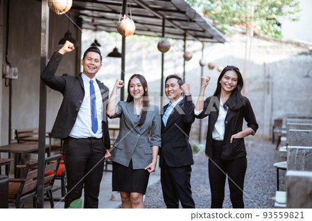 excited team of business people raised their arm 93559821