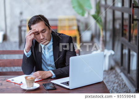 frustrated young businessman while working with his laptop frustrated young businessman while working with his laptop 93559848