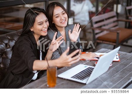 attractive asian female worker make a video call conference using smartphone attractive asian female worker make a video call conference using smartphone 93559864