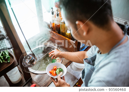 close up of the seller prepares the vegetables 93560468