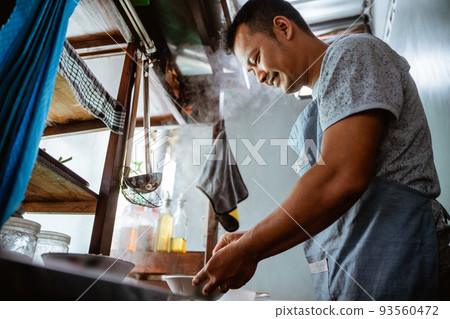 close up of a seller prepares the spices the bowl 93560472