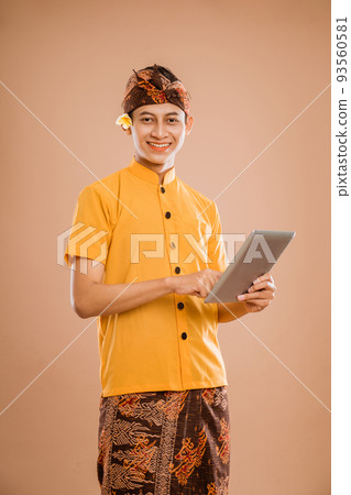 portrait of balinese young man using tablet pc portrait of balinese young man using tablet pc 93560581