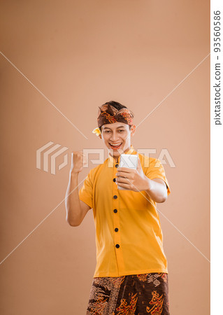 excited young balinese male put his hand up excited young balinese male put his hand up 93560586