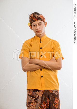 balinese young man presenting and pointing to copyspace balinese young man presenting and pointing to copyspace 93560637