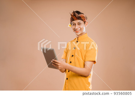 portrait of balinese young man using tablet pc portrait of balinese young man using tablet pc 93560805