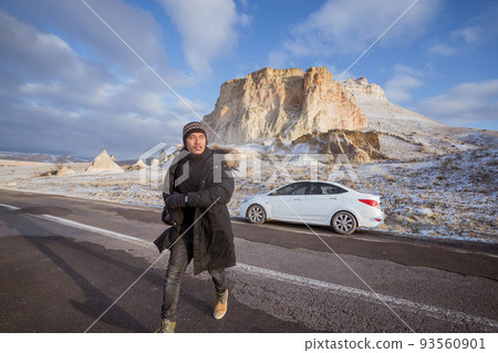 man on his adventure going to beautiful hill in cappadocia in winter by his car 93560901