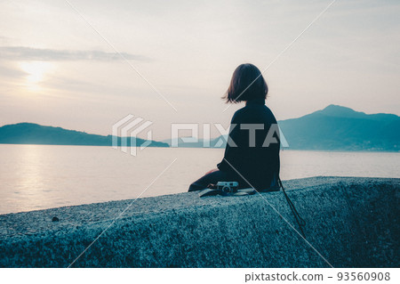 Beautiful sunset sky with a woman 93560908