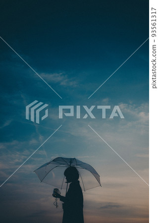 Female silhouette and beautiful sunset sky Female silhouette and beautiful sunset sky 93561317