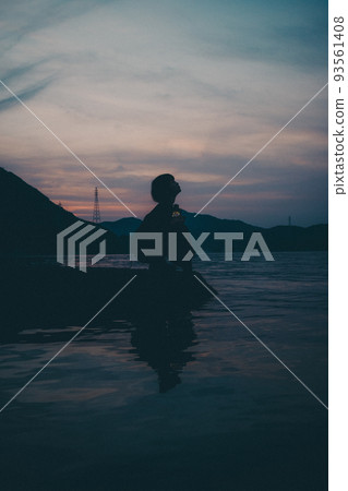 Female silhouette and beautiful sunset sky Female silhouette and beautiful sunset sky 93561408