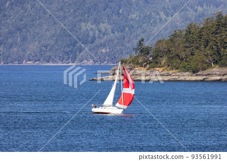 Sailboat in Canadian Landscape by the ocean and mountains. 93561991