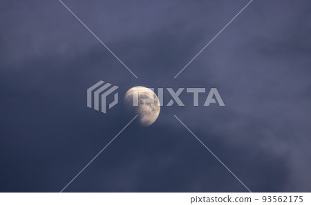 Moon in the sky covered with dark clouds Moon in the sky covered with dark clouds 93562175