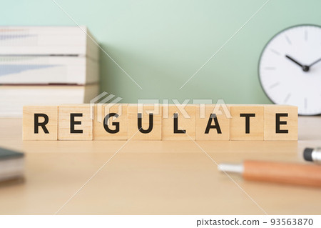 Image of regulations and adjustments | Desk with a block that says "REGULATE" 93563870
