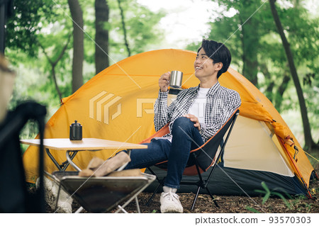 A man who enjoys solo camping and a man who drinks coffee A man who enjoys solo camping and a man who drinks coffee 93570303