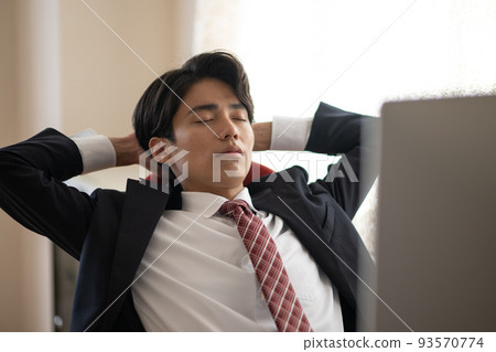 Young businessman tired from work in the office 93570774
