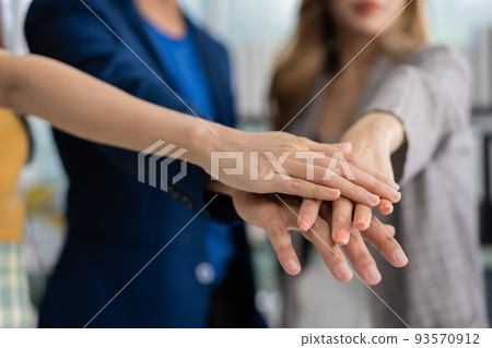 Group of Asia young entrepreneurs creative people join hand and excited for success project, working together in the office. Stratup business team discusses and shares ideas for new projects. 93570912