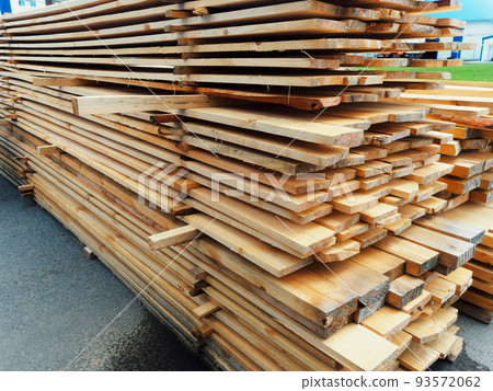 Wooden boards are stacked in a sawmill or carpentry shop. Sawing drying and marketing of wood Wooden boards are stacked in a sawmill or carpentry shop. Sawing drying and marketing of wood 93572062