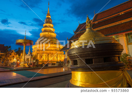 Wat Phra That Hariphunchai the iconic famous temple in Lamphun city, Northern Thailand at night. Wat Phra That Hariphunchai the iconic famous temple in Lamphun city, Northern Thailand at night. 93573860