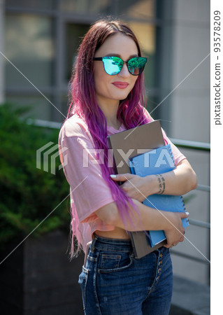 Portrait beautiful female writer dressed in casual outfit holding modern laptop in hand. Portrait beautiful female writer dressed in casual outfit holding modern laptop in hand. 93578209