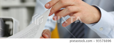 Male hands hold documents with financial statistics in closeup 93578896