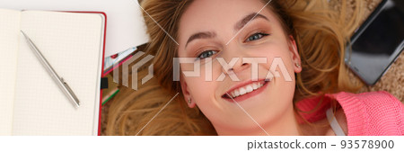 Portrait of beautiful woman lies on floor with diary Portrait of beautiful woman lies on floor with diary 93578900
