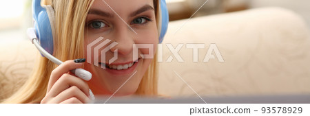 Portrait happy woman in headphones talking online with client via digital webcam 93578929