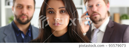 Portrait of young successful business woman and two businessmen in office Portrait of young successful business woman and two businessmen in office 93579073