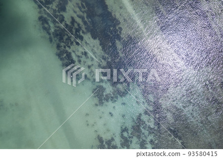 Sea surface aerial view, Bird eye view photo of seafoam waves, and water surface texture. Amazing view Top-down Sea surface aerial view, Bird eye view photo of seafoam waves, and water surface texture. Amazing view Top-down 93580415