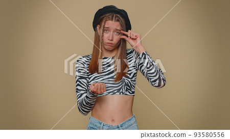 Woman showing a little bit gesture with sceptic smile, showing minimum sign, measuring small size Woman showing a little bit gesture with sceptic smile, showing minimum sign, measuring small size 93580556