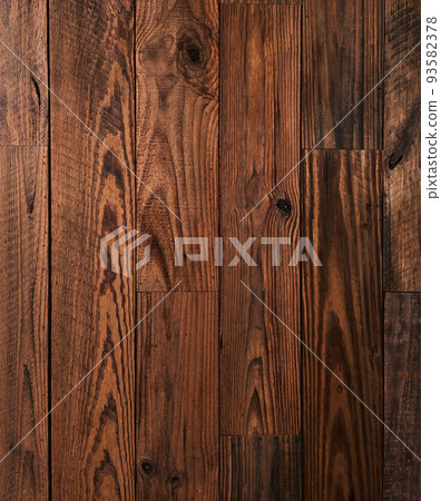 A background image of an old plank wall of dark brown rough sawn timber 93582378