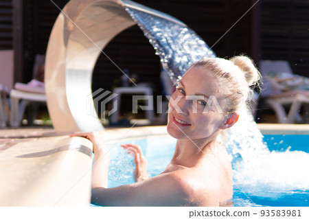 Smiling woman swimming young waterfall pool beautiful luxury outdoor relax, from therapy body from rest and splashing people, brunette drop. Joy lifestyle lady, Smiling woman swimming young waterfall pool beautiful luxury outdoor relax, from therapy body from rest and splashing people, brunette drop. Joy lifestyle lady, 93583981
