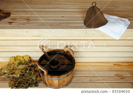 Sauna accessories on wooden benches 93584650