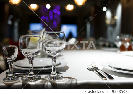 Wineglass and other cutlery on the festive table of restaraunt 93585084