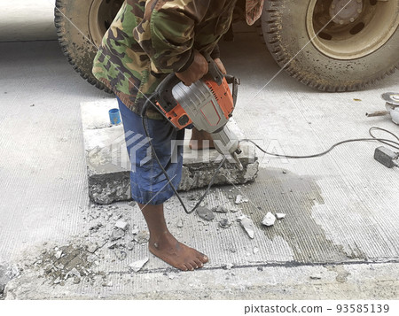 Real construction worker working on a cement pipe cap renovation. 93585139