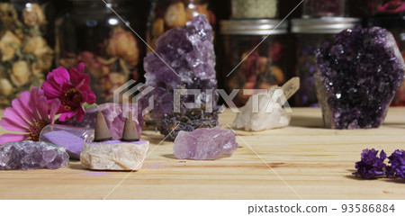 Amethyst Crystals With Flowers and Incense Cones on Meditation Table 93586884