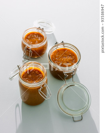 Salted caramel in glass jars. Vertical Salted caramel in glass jars. Vertical 93586947