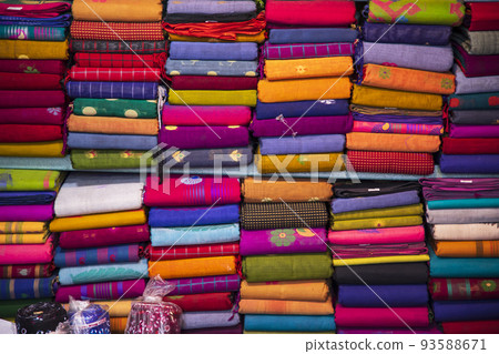 Artistic variety shade tone colors Saree's stacked on retail Shop Shelf to sale Artistic variety shade tone colors Saree's stacked on retail Shop Shelf to sale 93588671